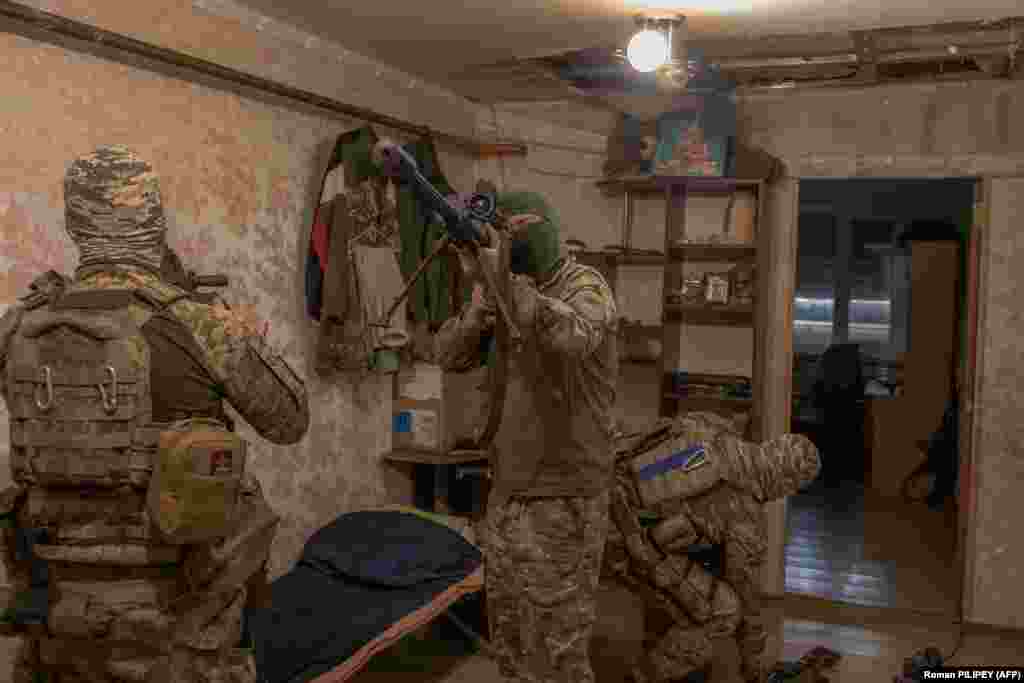 25 сентября. Украинский военный с позывным "Кузя" из элитного подразделения ВСУ "Призраки Бахмута" проверяет прицел. Он собирается на задание всего в нескольких сотнях метров от позиций российских войск на востоке Украины. Бои на том участке фронта – это преимущественно окопная война и дальние артиллерийские дуэли. Однако Кузя считает, что работа снайперов очень важна, она помогает украинским войскам продвигаться вперед