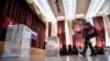 A woman casts her ballot during early voting at a polling station in Moscow on June 29. 
