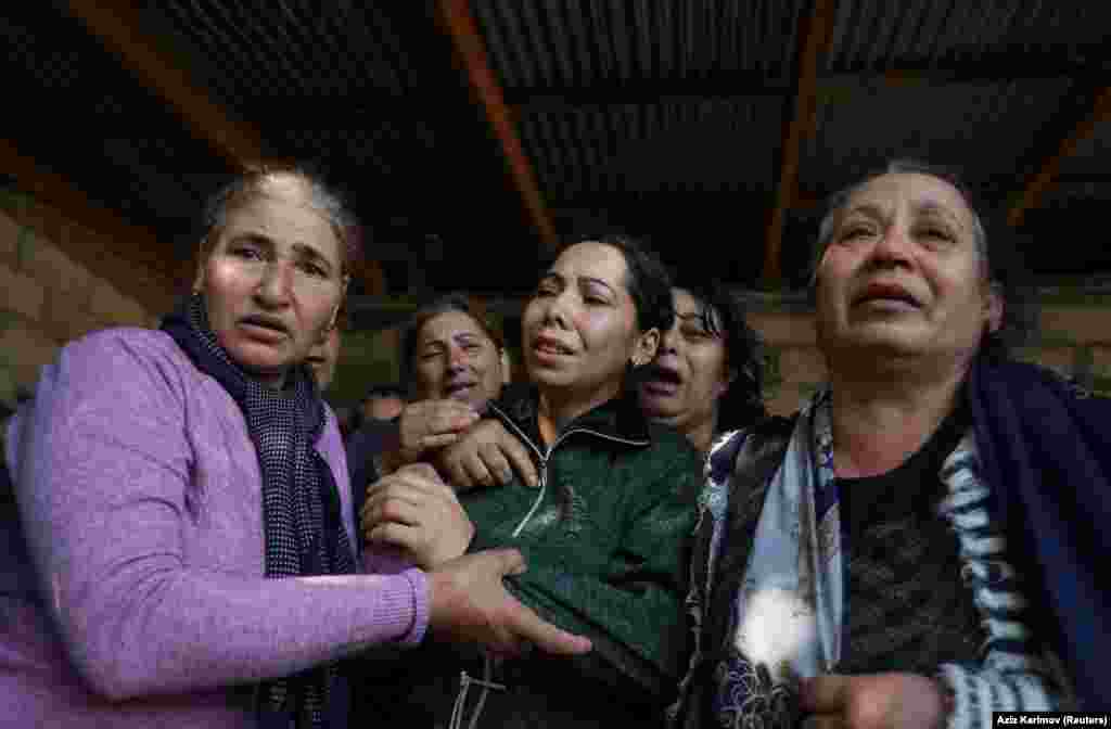 AZERBAIJAN -- Mourners attend a memorial service before the funeral of 7-year-old Aysu Isgandarova, who according to relatives and local media was killed by recent shelling in the course of a military conflict over the breakaway region of Nagorno-Karabakh