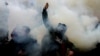 Ukrainian activists throw smoke flares during an October 30, 2020 rally outside Kyiv's Constitutional Court building. The demonstrators demanded that the judges come out and explain their reasons for ruling against criminal penalties for false financial disclosures by officials. 