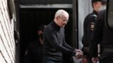  Russian historian Yury Dmitriyev, who was charged with sexually abusing his adopted daughter, is escorted by police officers after a court hearing in Petrozavodsk, Russia on July 22, 2020.