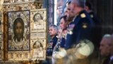 In this photo from the Russian Orthodox Church, Russian Defense Minister Sergei Shoigu (left) attends the June 14, 2020 consecration of the the country's new Cathedral of the Russian Armed Forces outside Moscow. 