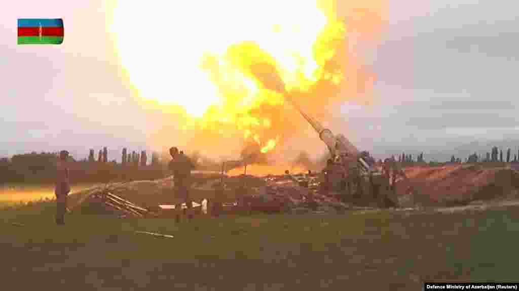 This frame from a video published by the Azerbaijani Defense Ministry shows soldiers firing artillery at Armenian and Karabakhi positions.